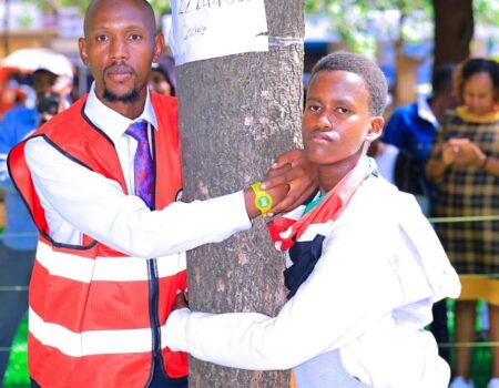 Geofrey Mosiria joins 14yrs boy in hugging a tree
