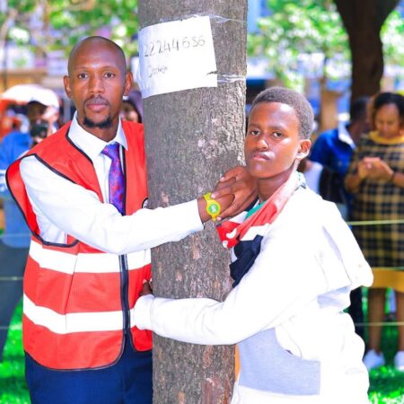 Geofrey Mosiria joins 14yrs boy in hugging a tree