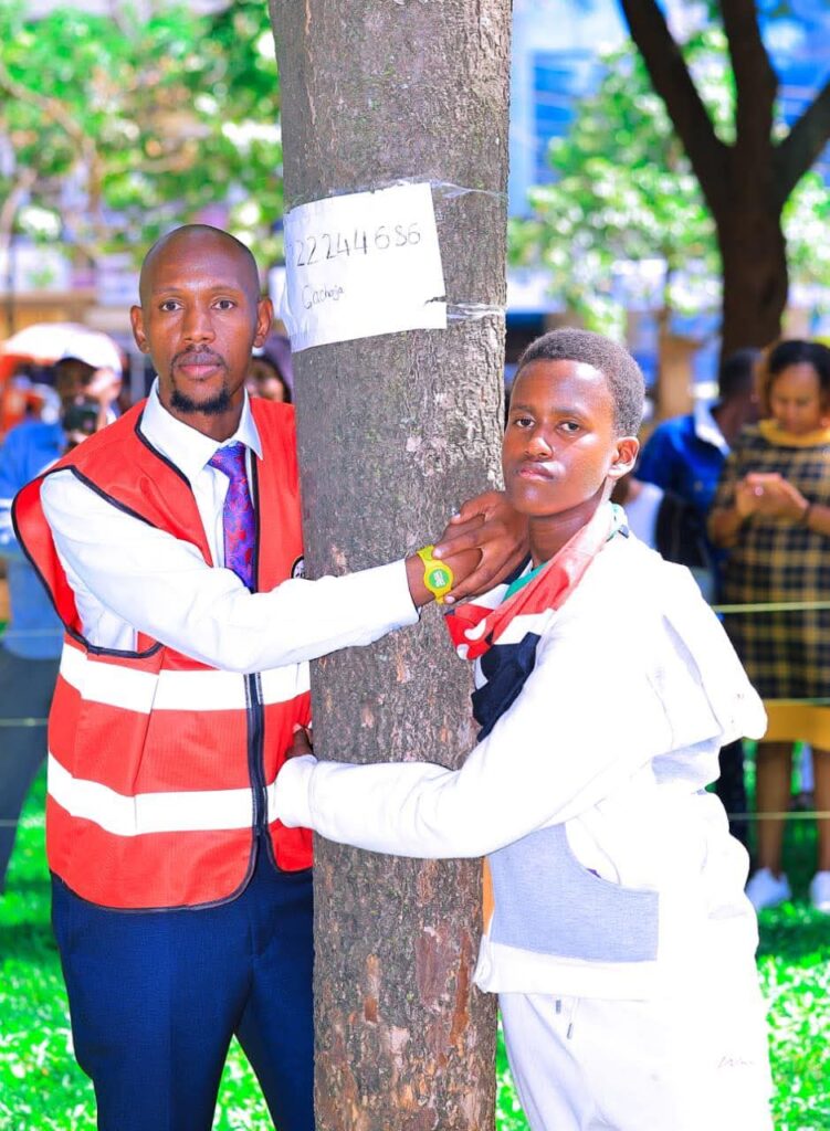 Geofrey Mosiria joins 14yrs boy in hugging a tree